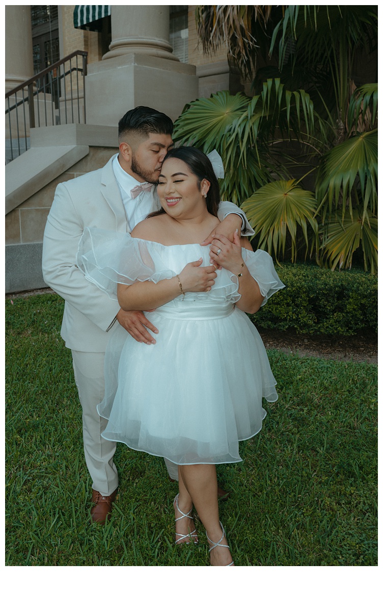 groom kissing brides temple