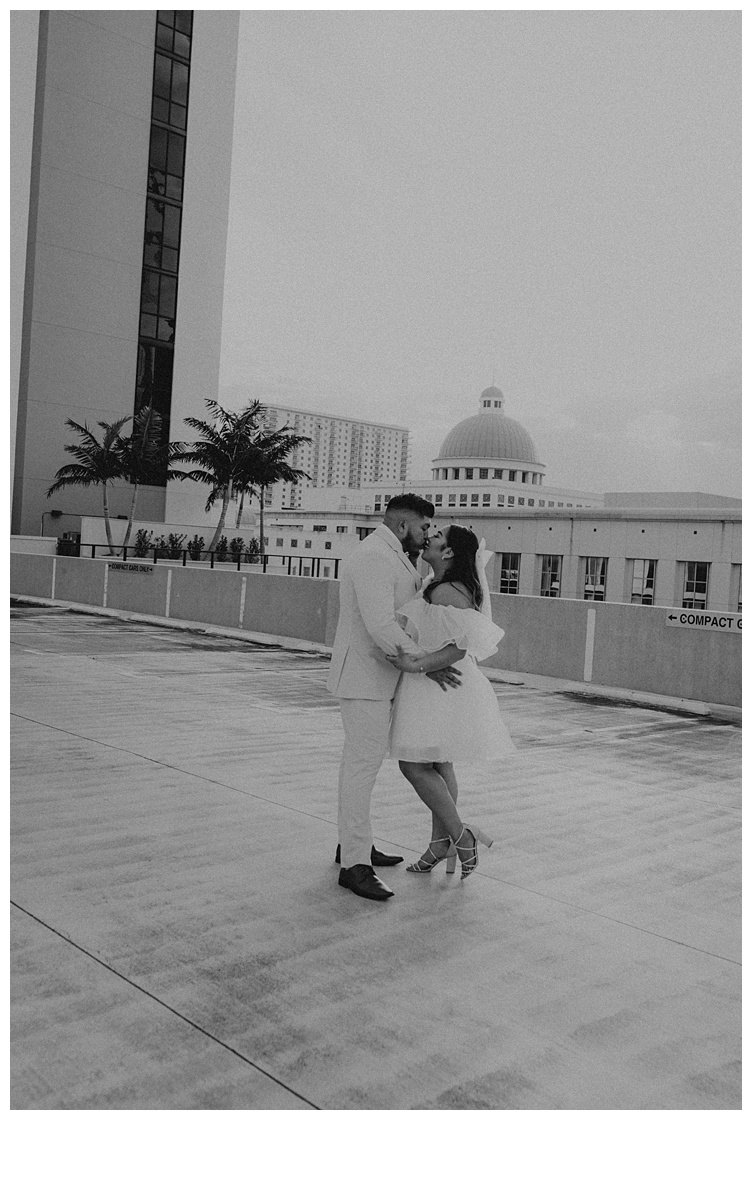 emotional kiss between bride and groom overlooking palm beach