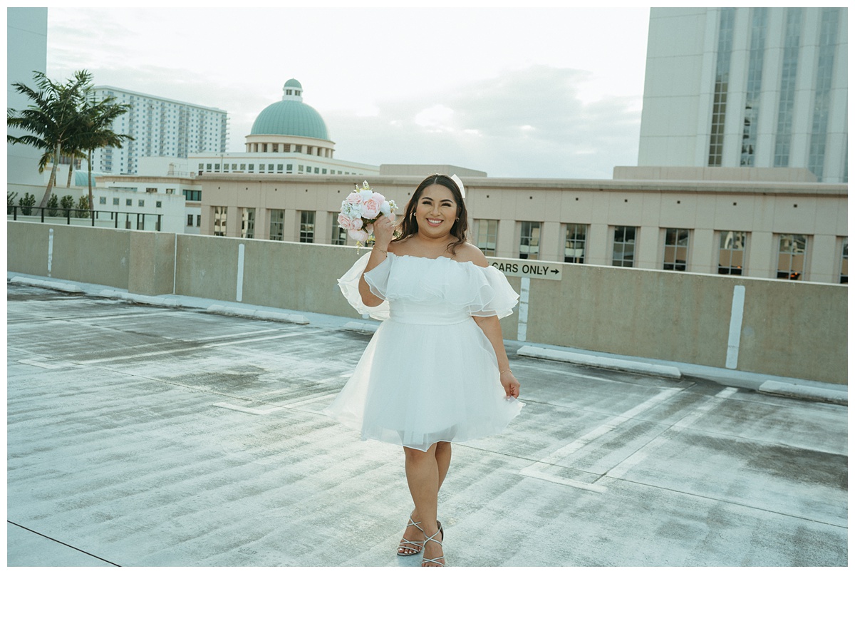 bride smiling at camera with bouquet 