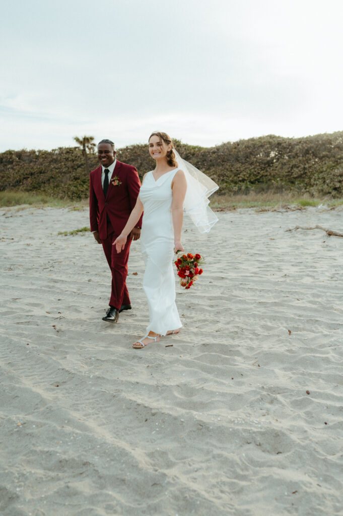 Bride and groom walking on the beach in Florida after their elopement