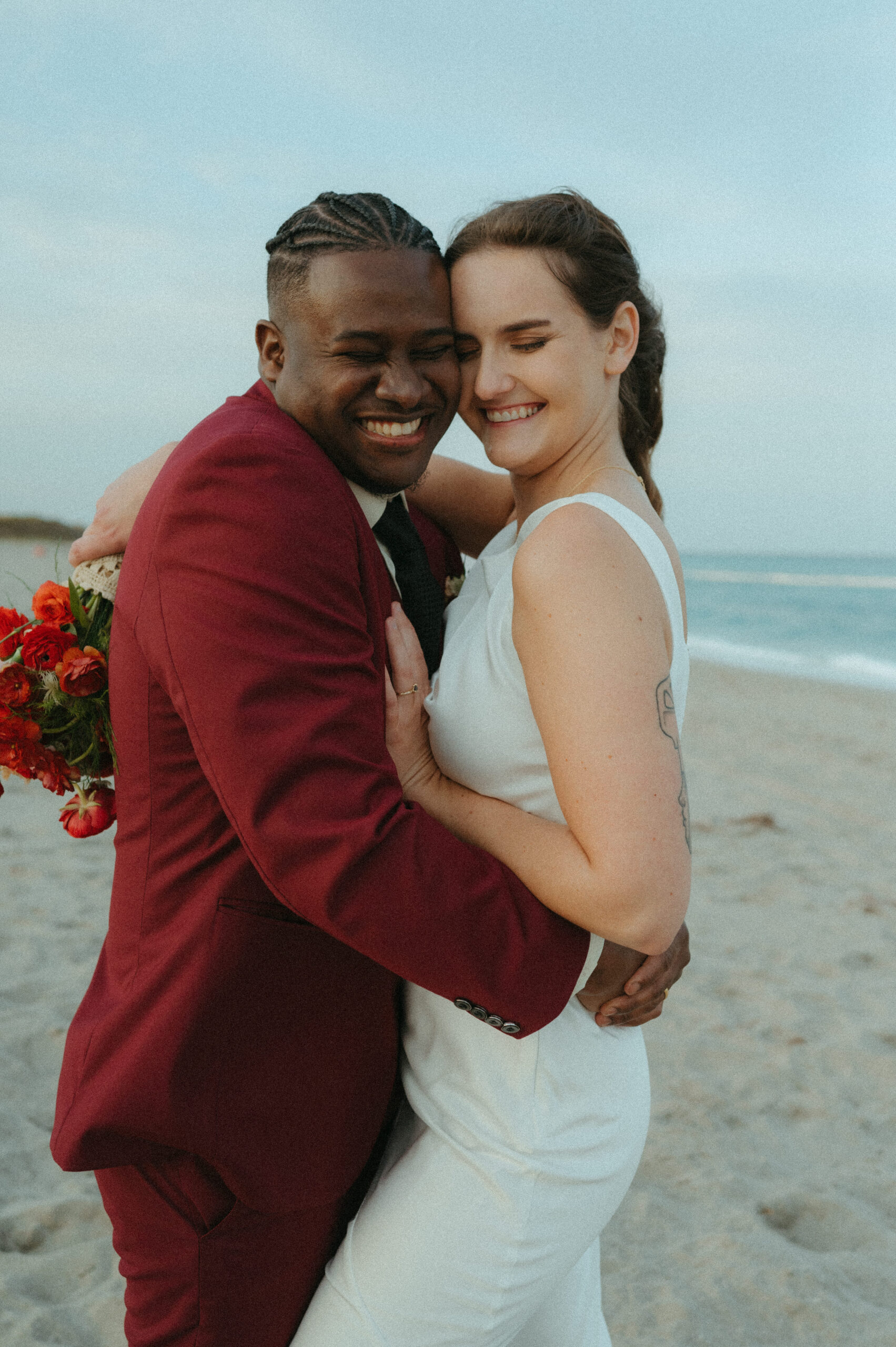 Bride and groom cuddling during their elopement on the beach in Florida