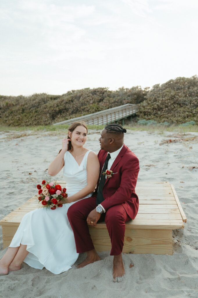 Bride and groom sitting on the beach after their Florida elopement