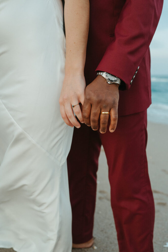 Bride and groom showing off their wedding rings after their beach elopement in Florida