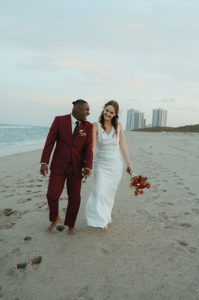 Bride and groom laughing after their beach elopement in Florida