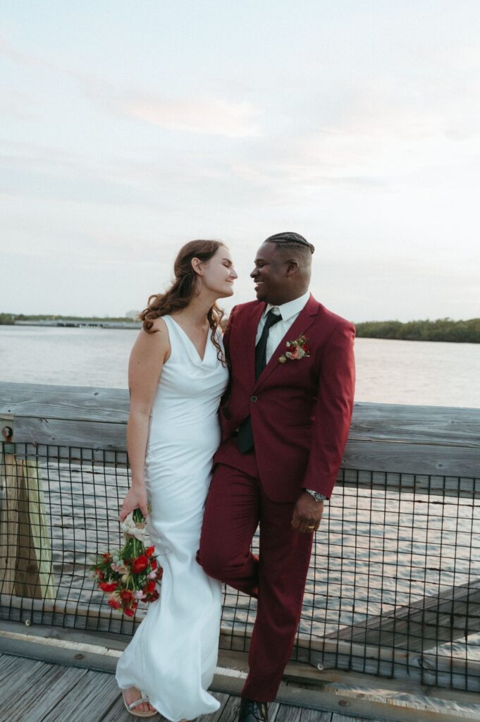 Bride and groom on a bridge after their beach elopement in Florida