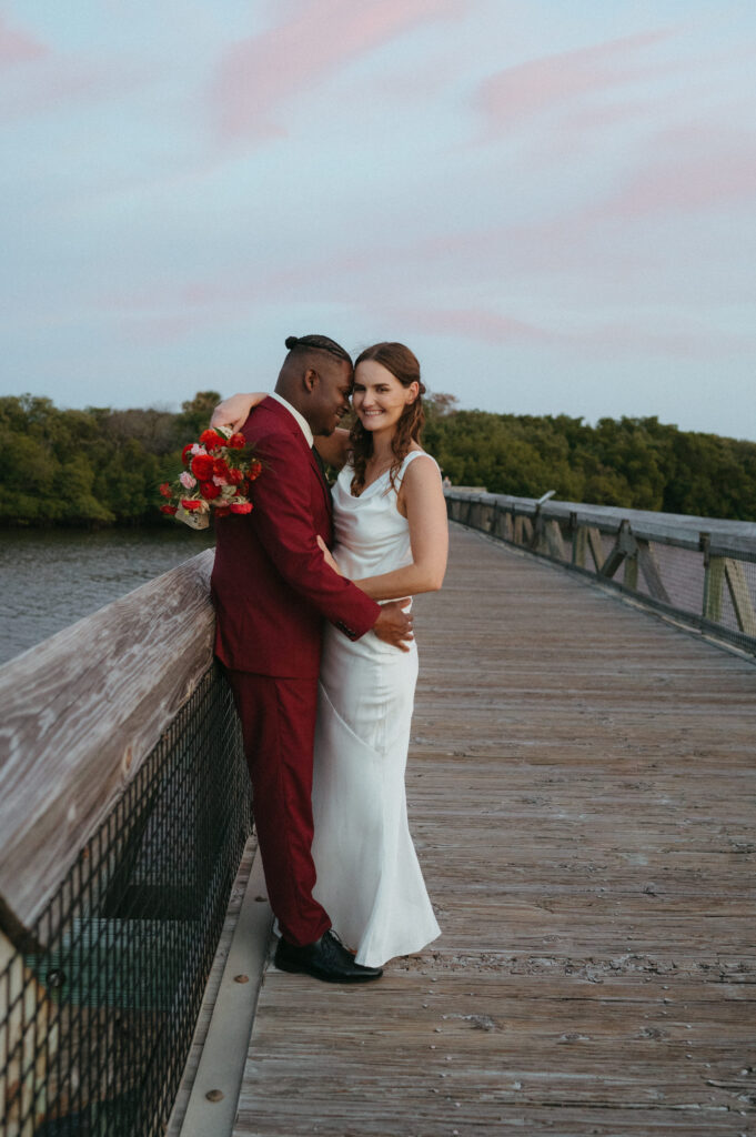 Bride and groom embracing on a bridge in Palm Beach Florida