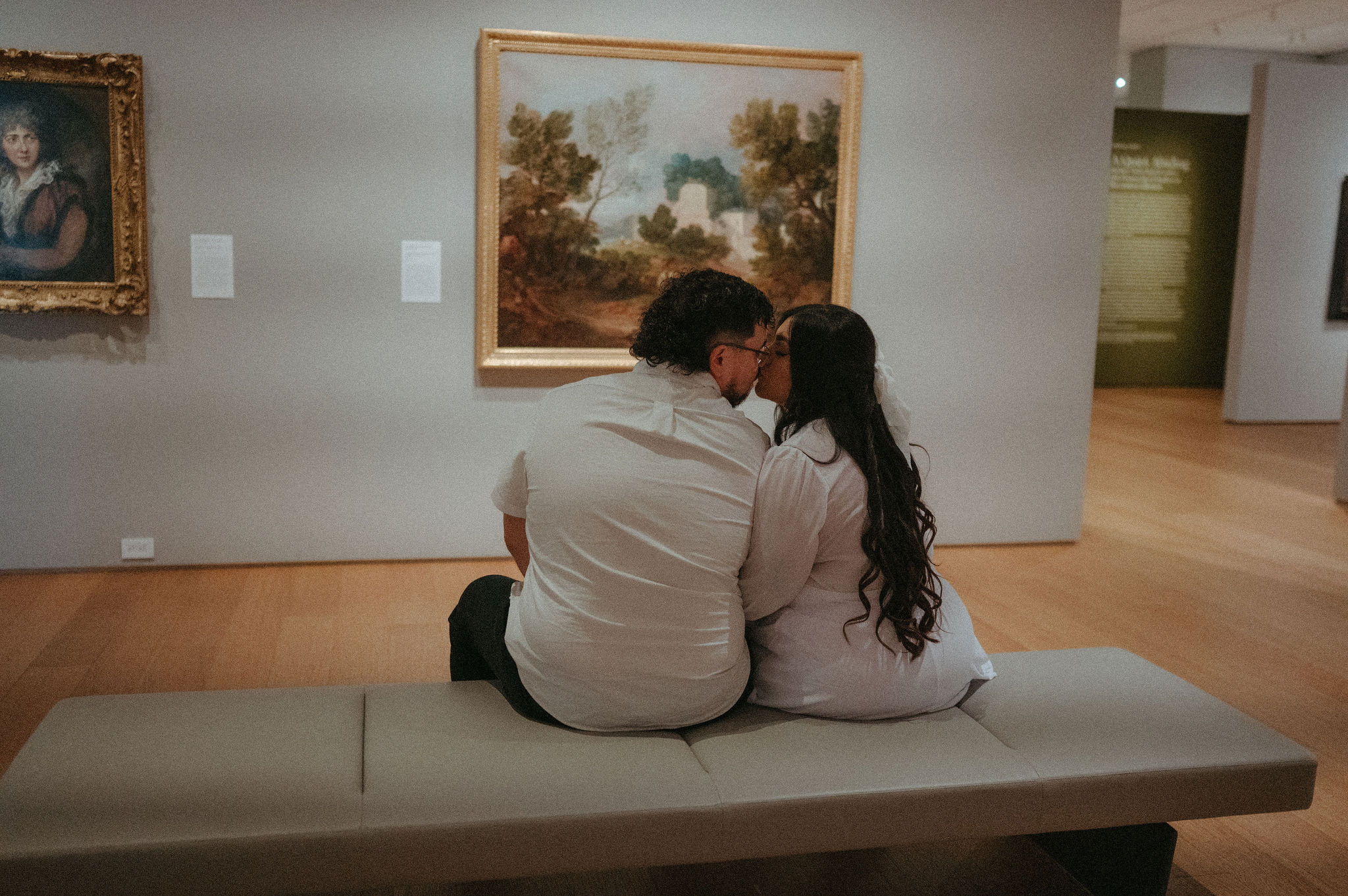 Norton Museum of Art engagement photos, a couple kissing in front of a piece of art