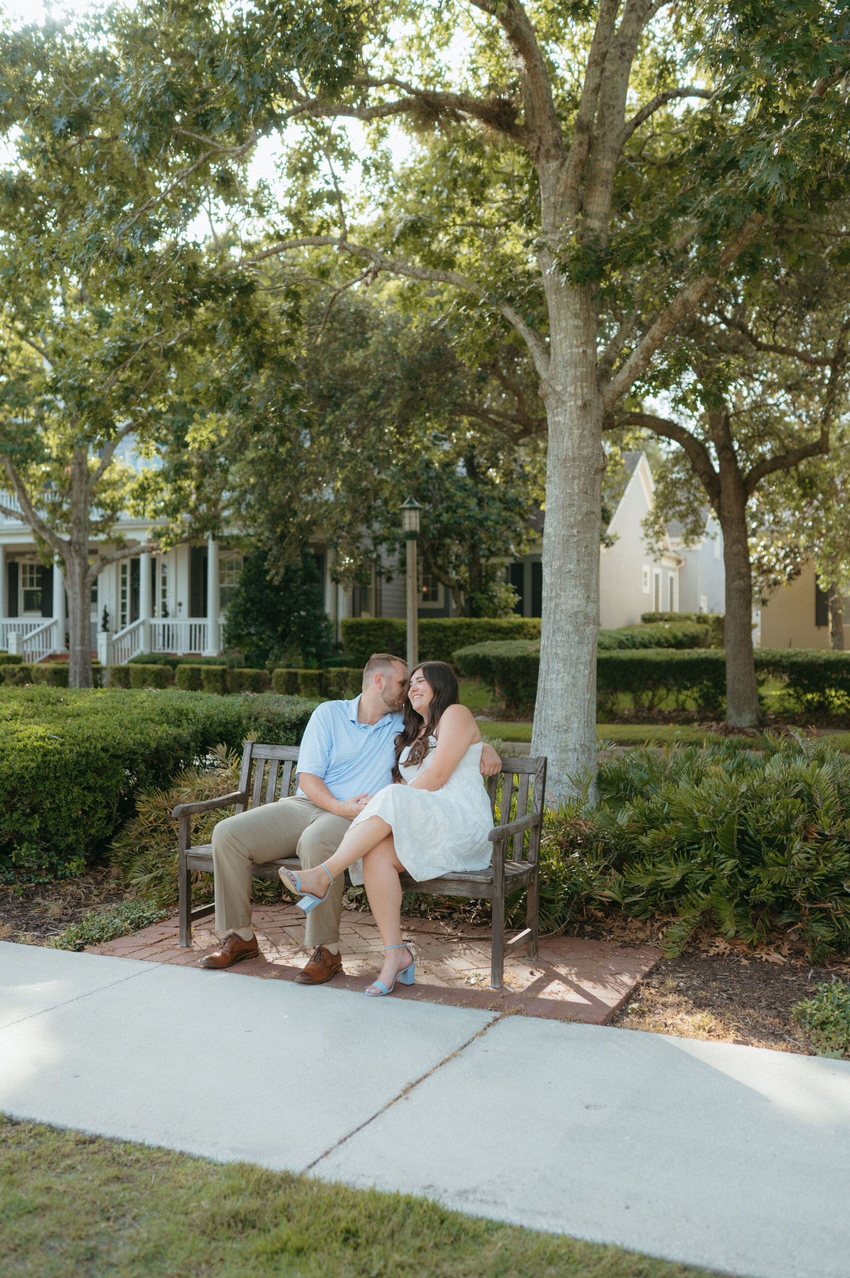 a man and a woman sitting on a bench cuddling at Savannah Square in Florida