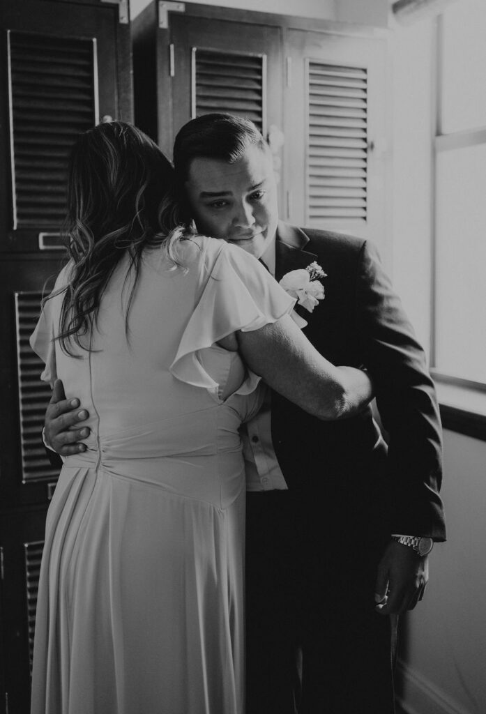 Groom hugging his mom before he gets married