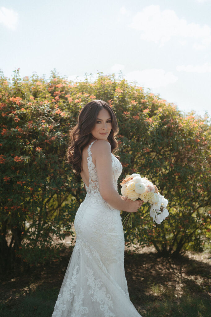 bride with a long lace wedding dress on holding her bouquet for her Florida wedding