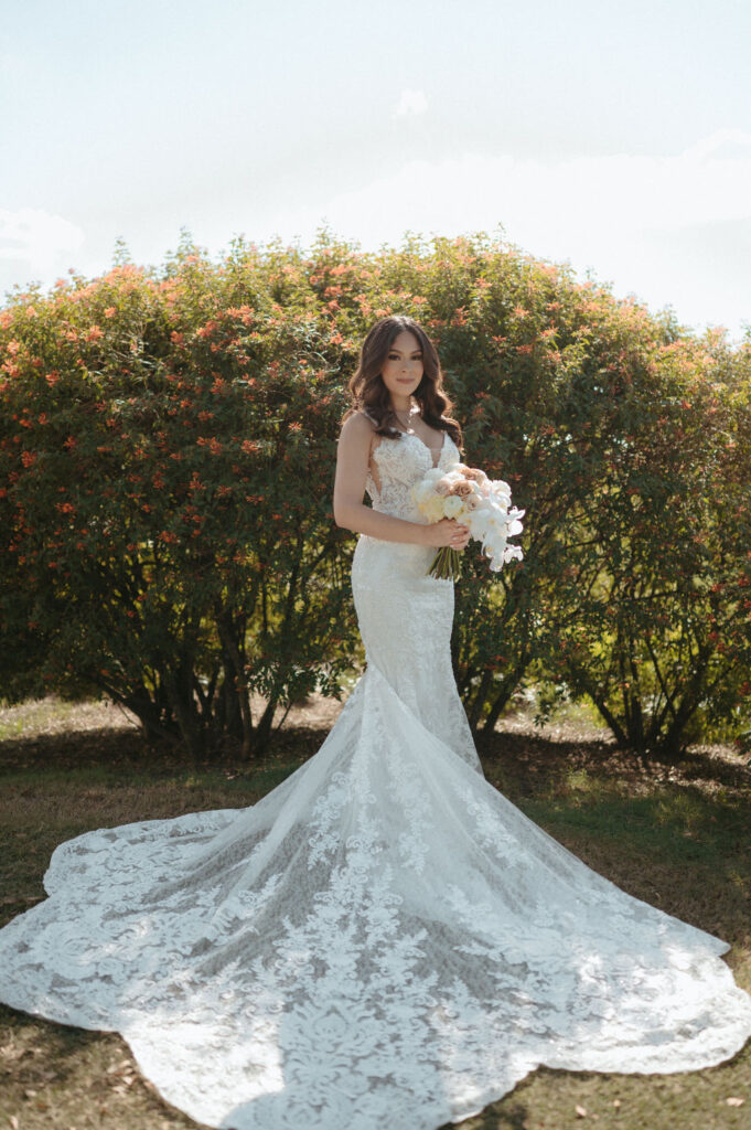 bride with a long lace wedding dress on holding her bouquet for her Florida wedding