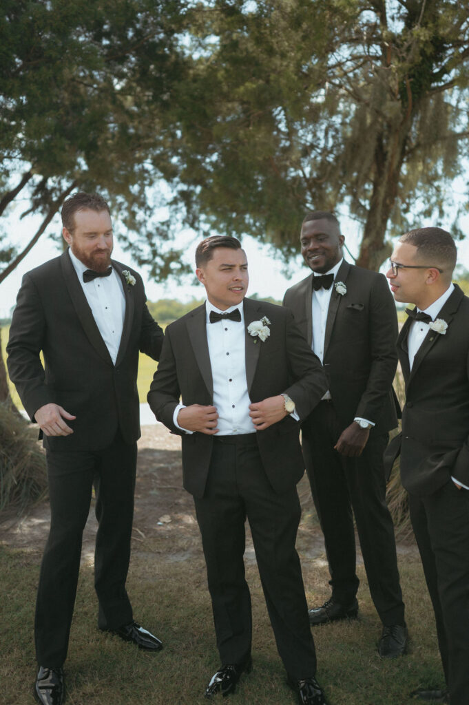 groom with his groomsmen wearing black tuxedos