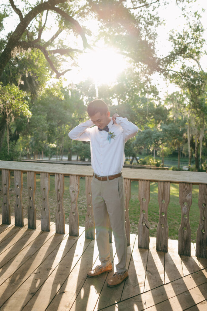 Groom getting ready before his elopement at Kelly Park Springs in Florida