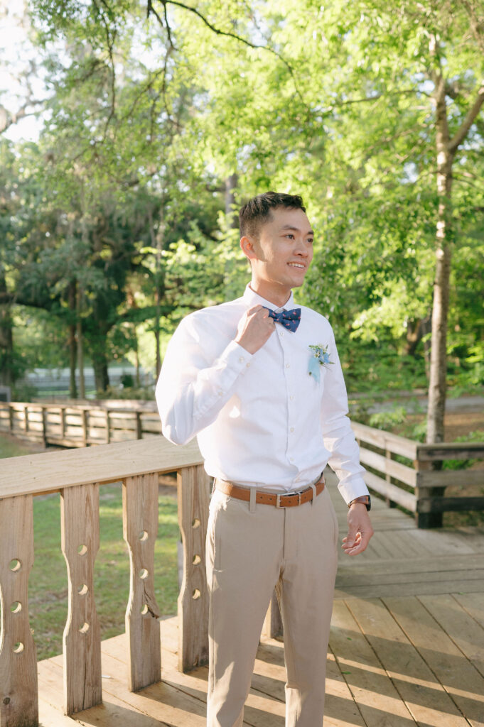 Groom getting ready before his elopement at Kelly Park Springs in Florida