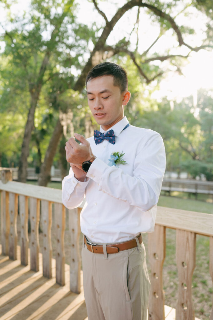 Groom getting ready before his elopement at Kelly Park Springs in Florida