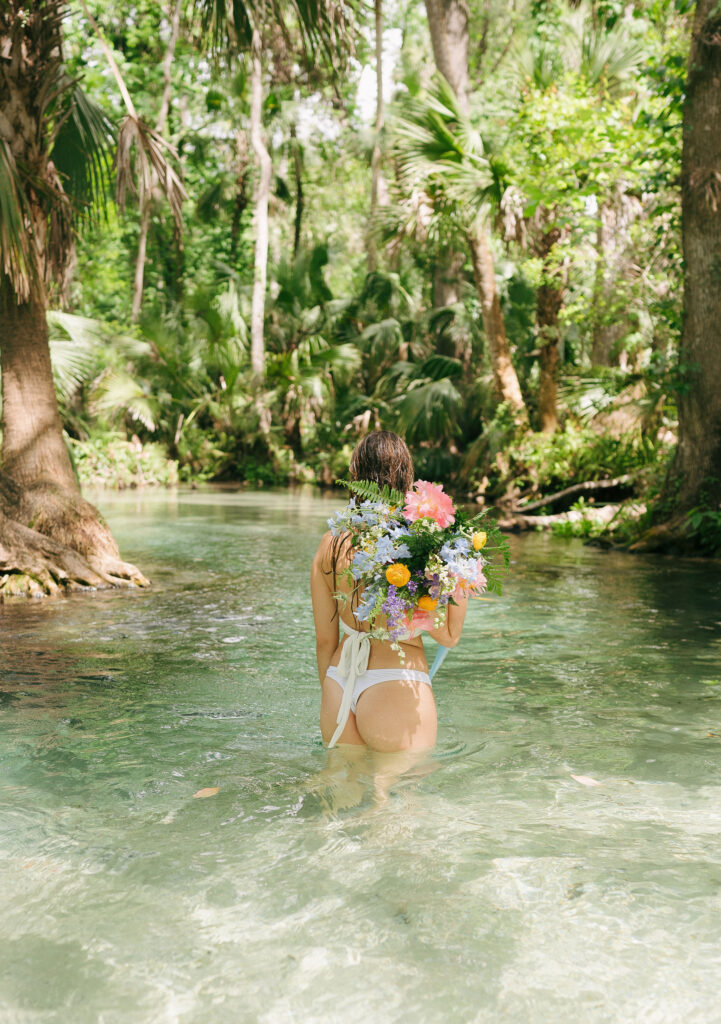 Intimate elopement photos in swimsuits at Kelly Park Springs in Florida